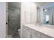 Bright bathroom view with vanity, sink, mirror, and a frameless marble tile shower enclosure at 7703 E Overlook Dr, Scottsdale, AZ 85255