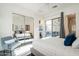 Sunlit bedroom featuring a plush bed, mirrored closet, and patio access at 7703 E Overlook Dr, Scottsdale, AZ 85255