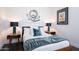 Bedroom view of a wood frame bed with side tables, lamps, and decorative wall art at 7703 E Overlook Dr, Scottsdale, AZ 85255