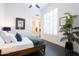 This bedroom includes a large window, plant, ceiling fan, and an ensuite bath at 7703 E Overlook Dr, Scottsdale, AZ 85255