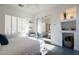 Bright bedroom featuring a large window with white shutters and recessed shelving at 7703 E Overlook Dr, Scottsdale, AZ 85255
