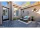 Cozy outdoor courtyard features a seating area, tiled floors, and decorative wall art at 7703 E Overlook Dr, Scottsdale, AZ 85255