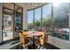 Dining area with large windows offers views of the pool and backyard waterfall feature at 7703 E Overlook Dr, Scottsdale, AZ 85255