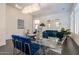 Bright dining area with a glass table, velvet chairs, and view to the living room at 7703 E Overlook Dr, Scottsdale, AZ 85255