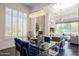 Modern dining room showcasing a contemporary chandelier, shutters, and open floor plan at 7703 E Overlook Dr, Scottsdale, AZ 85255