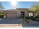 Beautiful single-story home features a well-manicured landscape and a two-car garage at 7703 E Overlook Dr, Scottsdale, AZ 85255