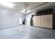 Functional garage space with ample storage cabinets, and a door to the outside at 7703 E Overlook Dr, Scottsdale, AZ 85255