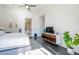 Cozy main bedroom with TV, view of the bathroom, hardwood floors, and a modern design at 7703 E Overlook Dr, Scottsdale, AZ 85255