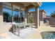 Cozy outdoor dining area on the patio, complemented by stylish furniture and serene poolside views at 7703 E Overlook Dr, Scottsdale, AZ 85255