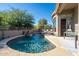 Backyard pool featuring waterfall and lounge chairs, surrounded by lush landscaping at 7703 E Overlook Dr, Scottsdale, AZ 85255