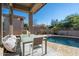 Inviting outdoor space with a covered patio, pool, and seating area at 7703 E Overlook Dr, Scottsdale, AZ 85255
