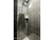 This modern tiled shower features gray tile, a large showerhead and a convenient corner shelf at 7703 E Overlook Dr, Scottsdale, AZ 85255