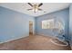Bedroom with a ceiling fan, carpet, natural light and a hanging chair for relaxing at 824 E Chelsea Dr, San Tan Valley, AZ 85140