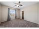 Neutral bedroom with a ceiling fan, plush carpeting, window and closet, perfect for comfort at 824 E Chelsea Dr, San Tan Valley, AZ 85140