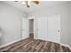 Cozy bedroom features wood-look flooring, white trim, sliding closet doors, and neutral paint at 824 E Chelsea Dr, San Tan Valley, AZ 85140