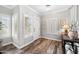 Welcoming entryway featuring hardwood floors, white walls, and shuttered windows offering plenty of natural light at 824 E Chelsea Dr, San Tan Valley, AZ 85140