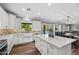 Modern kitchen featuring white cabinets, marble countertops and backsplash, and stainless steel appliances at 824 E Chelsea Dr, San Tan Valley, AZ 85140