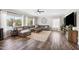 Spacious living room offers a large gray sectional, hardwood floors, natural light, and a ceiling fan at 824 E Chelsea Dr, San Tan Valley, AZ 85140