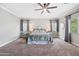 Main bedroom showcases neutral tones, carpeting, a ceiling fan, and dual end tables at 824 E Chelsea Dr, San Tan Valley, AZ 85140