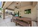 Covered patio with wood table, bench, ceiling fan, and view of the pool at 824 E Chelsea Dr, San Tan Valley, AZ 85140