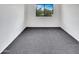 Bright bedroom with gray carpet and a window overlooking greenery and blue sky at 8711 N 67Th Dr, Peoria, AZ 85345