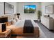 Serene bedroom features a large window, light-colored walls, and elegant contemporary furnishings at 8711 N 67Th Dr, Peoria, AZ 85345