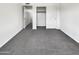 Neutral bedroom featuring gray carpet, white walls and doors, and closet at 8711 N 67Th Dr, Peoria, AZ 85345