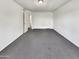 Large bedroom features gray carpet, neutral walls, and open closet with lighting at 8711 N 67Th Dr, Peoria, AZ 85345
