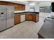 Well-lit kitchen featuring stainless steel appliances, dark countertops, and ample cabinetry at 8711 N 67Th Dr, Peoria, AZ 85345