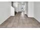 View of living room and staircase, showing neutral tile floors and freshly painted walls at 8711 N 67Th Dr, Peoria, AZ 85345