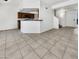 Open-concept living room with tile floors, and view of the kitchen and staircase at 8711 N 67Th Dr, Peoria, AZ 85345