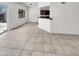 Neutral living space with tile flooring and view of the kitchen in the background at 8711 N 67Th Dr, Peoria, AZ 85345