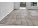 Bright living space with neutral tile floors and sliding glass door access to the backyard at 8711 N 67Th Dr, Peoria, AZ 85345