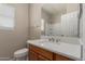 Well-lit bathroom features a white quartz countertop and framed mirror at 10245 W Parkway Dr, Tolleson, AZ 85353