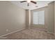 This bedroom features a ceiling fan and carpet flooring at 10245 W Parkway Dr, Tolleson, AZ 85353