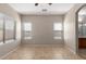 Bright bedroom features a ceiling fan and tile flooring at 10245 W Parkway Dr, Tolleson, AZ 85353