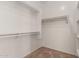 A walk-in closet features custom shelving and carpet flooring at 10245 W Parkway Dr, Tolleson, AZ 85353
