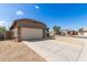 A single-Gathering home with a two-car garage, desert landscaping, and extended concrete driveway at 10245 W Parkway Dr, Tolleson, AZ 85353