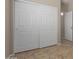 Hallway closet features sliding white doors and tile flooring at 10245 W Parkway Dr, Tolleson, AZ 85353