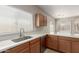 Bright kitchen features stainless steel sink, updated counter tops, and wood cabinets at 10245 W Parkway Dr, Tolleson, AZ 85353