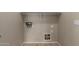 Spacious laundry room with convenient shelf and tiled floor at 10245 W Parkway Dr, Tolleson, AZ 85353