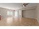 Open-concept living room boasts tile floors, neutral walls, and lots of natural light at 10245 W Parkway Dr, Tolleson, AZ 85353