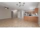 Open-concept living space with tile floors, ceiling fans, and a seamless flow to the kitchen at 10245 W Parkway Dr, Tolleson, AZ 85353