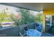Enjoy the serene view from this spacious balcony with table, chairs, and trees at 1111 W University Dr # 2012, Tempe, AZ 85281