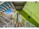 Modern building with vibrant green exterior walls and open stairway access to residences at 1111 W University Dr # 2012, Tempe, AZ 85281