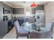 Stylish kitchen with stainless steel appliances, gray cabinetry, and a dining table at 1111 W University Dr # 2012, Tempe, AZ 85281