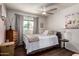Comfortable bedroom with neutral tones, ceiling fan, and wood flooring at 1153 W Mesquite St, Chandler, AZ 85224