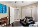 Bedroom features a comfortable black leather chair with an ottoman and bright decor, offering a relaxing retreat at 1153 W Mesquite St, Chandler, AZ 85224