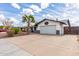 Welcoming house with desert landscape, palm tree, and a large driveway at 1153 W Mesquite St, Chandler, AZ 85224