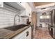 Well-lit kitchen featuring stainless steel appliances, tiled backsplash, and wooden countertops at 1153 W Mesquite St, Chandler, AZ 85224